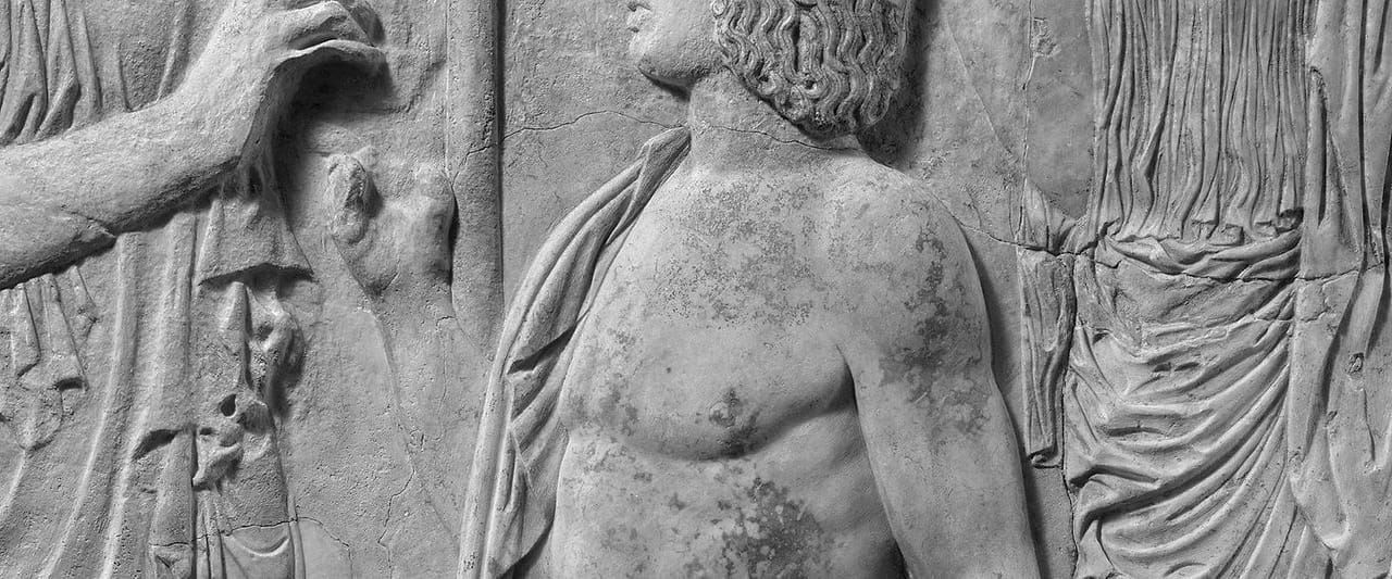 Carved marble fragments of a Roman relief, weathered and broken at the edges.